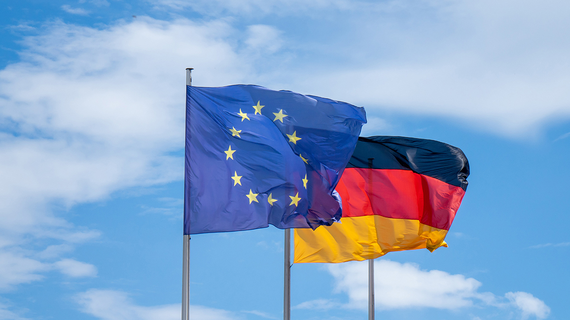 Flags of the European Union and the Federal Republic of Germany are blowing in the wind.